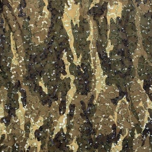 May include: Camouflage fabric with gold and silver sequins. The fabric has a mesh-like texture.