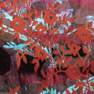 May include: Red floral pattern on a dark brown fabric background. The floral pattern is a silhouette of leaves and flowers.