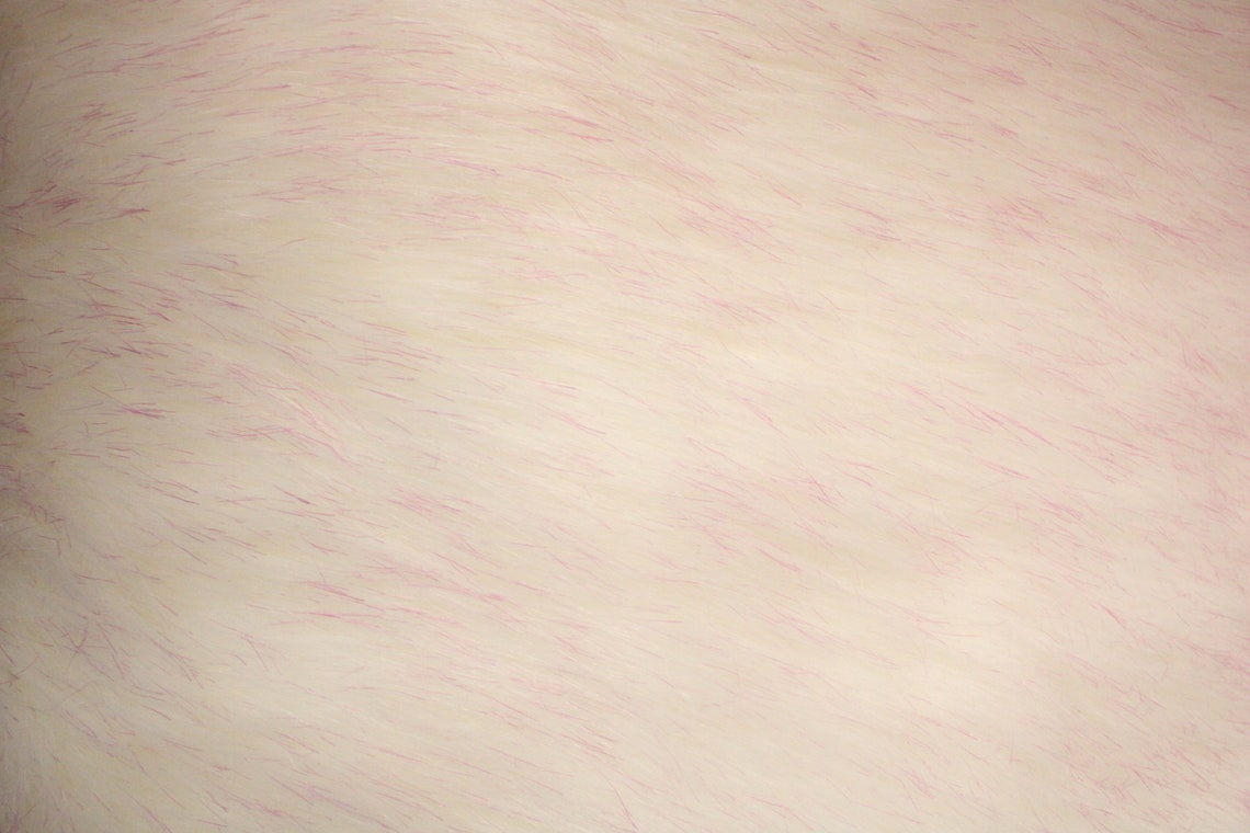 Close-up of a 60-inch wide frosted shag faux fur fabric in white and pink, showcasing its layered, textured design ideal for fall-inspired styles.