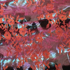 May include: A close-up of a fabric with a red floral pattern on a dark purple background. The flowers are embossed and have a 3D effect.