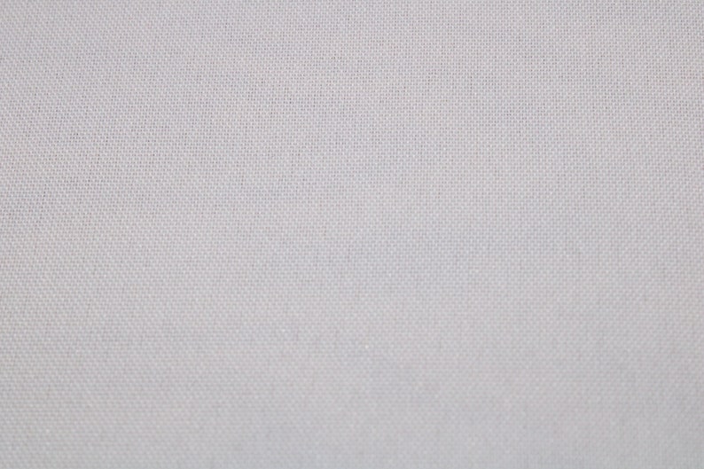 May include: A close-up of a plain white fabric with a subtle woven texture.