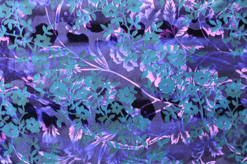 May include: A purple and teal floral fabric with a repeating pattern of stylized flowers and leaves.