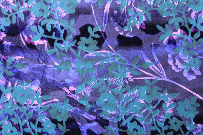 May include: A purple and teal floral fabric with a repeating pattern of leaves and flowers.