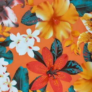 May include: A vibrant orange background with a tropical floral print featuring yellow, orange, white, and red flowers. The flowers are arranged in a random pattern and are surrounded by green leaves.
