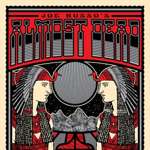 May include: A red and black poster with the text "Joe Russo's Almost Dead" in a stylized font. The poster features two figures with headdresses and a red sun in the background. The text "Dec. 15 2016 Denver CO Ogden Theatre Dec. 16 2016 Boulder CO Boulder Theater" is at the bottom of the poster.