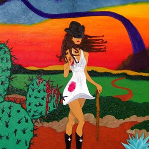 May include: A woman in a white dress and black hat walks through a desert landscape with a walking stick. The background is a vibrant orange and red sunset with a purple rainbow. The woman is wearing black boots and has long brown hair. There are cacti in the foreground.