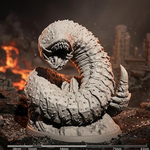May include: A detailed, gray sculpture of a monstrous worm-like creature with a gaping maw and spiky exterior. The creature is coiled, with a large, curved horn-like appendage. The sculpture is set against a blurred, fiery background, suggesting a fantasy or sci-fi theme.