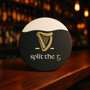 Op de afbeelding: Een ronde zwarte en witte bierviltje met de tekst "split the 5" in gouden letters. Het heeft een gouden harp logo en ligt op een houten bar.