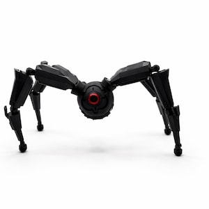 May include: A black, mechanical spider-like robot with eight articulated legs. The central body features a red circular element, possibly a sensor or eye. The robot is designed with geometric shapes and appears to be made of plastic.