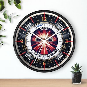 May include: Round black wall clock with a white face featuring the text "Haiti Road to World Cup 2026". The clock has red and gold accents, with a stadium graphic in the center.