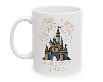 May include: White ceramic mug featuring a blue and gold castle illustration with fireworks and the text "CASTLE STATE of MIND". The mug has a curved handle and is designed for hot beverages.