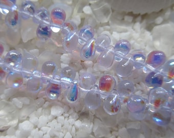 May include: A strand of iridescent light purple glass beads in a teardrop shape.