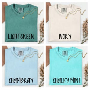 The image is a collage of four different t-shirt designs, each with a unique color and label. The t-shirts are arranged in a square format, with each design displayed in a separate image.