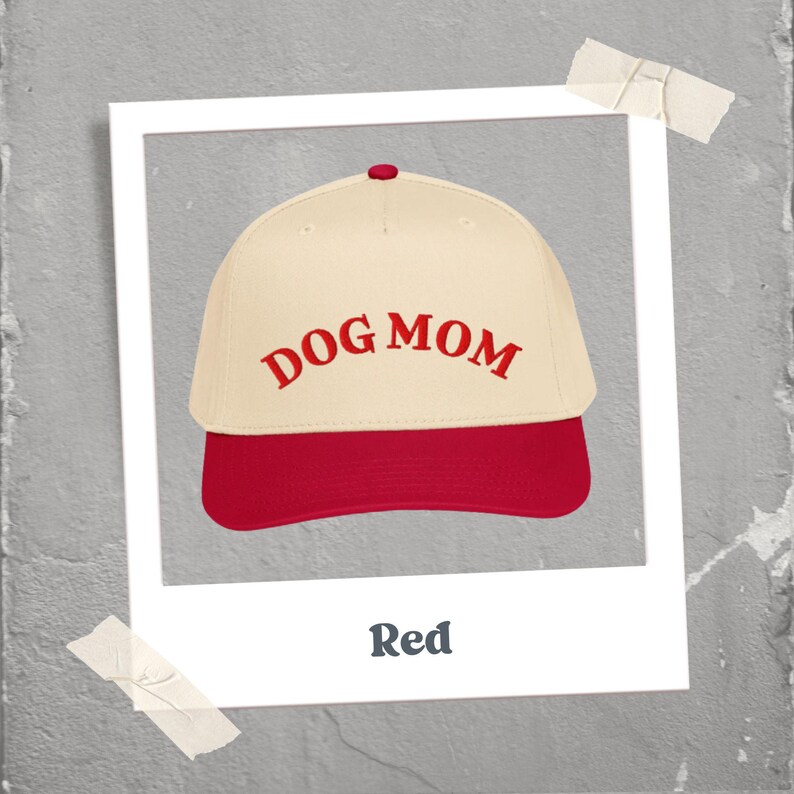 May include: A baseball cap with a cream-colored crown and a red brim. The words "DOG MOM" are embroidered in red across the front. The image is framed in a white border with the word "Red" at the bottom.
