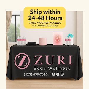 May include: A black table cover with the ZURI Body Wellness logo in pink. The text "Ship within 24-48 Hours" is in a yellow rectangle. The table displays water bottles, towels, and a pink box with the ZURI logo.
