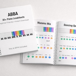 May include: A spiral-bound book with the text "ABBA 30+ Piano Leadsheets" and a piano keyboard graphic. The book is open to show lead sheets for "Mamma Mia" and "Dancing Queen" with colored notes. The text "Key & BPM Included" is also visible.