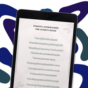 May include: A black tablet displays a document with the title "POSITIVE AFFIRMATIONS FOR ANXIETY RELIEF." The text includes affirmations like "I am safe in this moment" and "I choose peace over worry." The tablet is set against a background with blue and white abstract shapes. The words "Emotional Reset kit" are at the top.