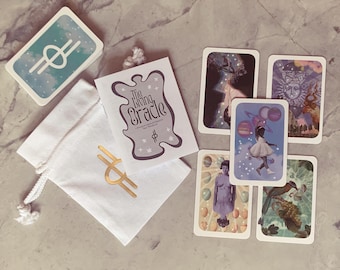 May include: A set of oracle cards with a white bag and a card with the text "The Living Oracle" in a whimsical font. The cards feature illustrations of celestial bodies, people, and nature.