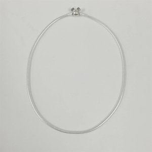 May include: A silver-colored necklace with a round, snake-like chain. The clasp features a small, decorative design. The necklace is displayed against a plain white background, highlighting its simple elegance.