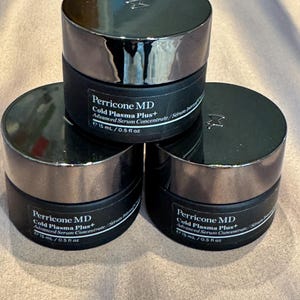 May include: Three black cosmetic jars with silver lids are stacked. Each jar is labeled "Perricone MD Cold Plasma Plus+ Advanced Serum Concentrate" and contains 15 mL / 0.5 fl oz. The jars are arranged in a triangular formation.