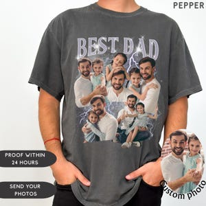 May include: Dark gray t-shirt with a custom photo design. The shirt features the text "BEST DAD" in a light purple font, with a collage of photos of a man and children. The word "PEPPER" is printed at the top right.