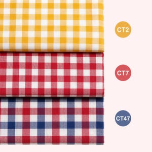 May include: Three folded fabric swatches featuring a classic gingham check pattern. The top swatch is yellow and white, the middle is red and white, and the bottom is red, blue, and white. Each swatch is labeled with a circular tag: CT2, CT7, and CT47.