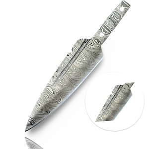 May include: A Damascus steel knife blade with a distinctive swirling pattern. The blade has a pointed tip and a handle with two holes for attachment. A smaller, circular inset shows a detail of the blade.