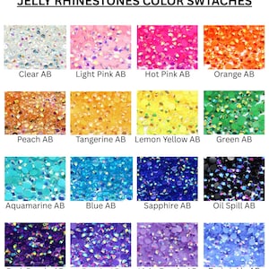 May include: A grid of jelly rhinestone color swatches labeled JELLY RHINESTONES COLOR SWTACHES. The sixteen circular samples include Clear AB, Light Pink AB, Hot Pink AB, Orange AB, Peach AB, Tangerine AB, Lemon Yellow AB, Green AB, Aquamarine AB, Blue AB, Sapphire AB, Oil Spill AB, Dark Purple AB, Purple AB, Light Purple AB, and Periwinkle AB.