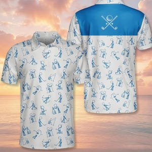 May include: A white polo shirt featuring a repeating blue pattern of stick figures playing golf. The shirt has a collar and short sleeves. The back panel includes a solid blue horizontal section across the shoulders with a white graphic of two crossed golf clubs and a golf ball.