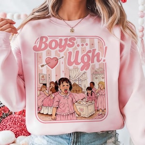 May include: Pink sweatshirt with a graphic that says "Boys... Ugh!" in pink bubble letters. The graphic features a heart pierced by an arrow and a cartoon illustration of girls in a bedroom.