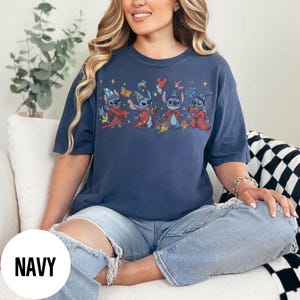 May include: A white ceramic mug with a black handle and the text "But First, Coffee" in a black, handwritten-style font. The mug is on a white surface.