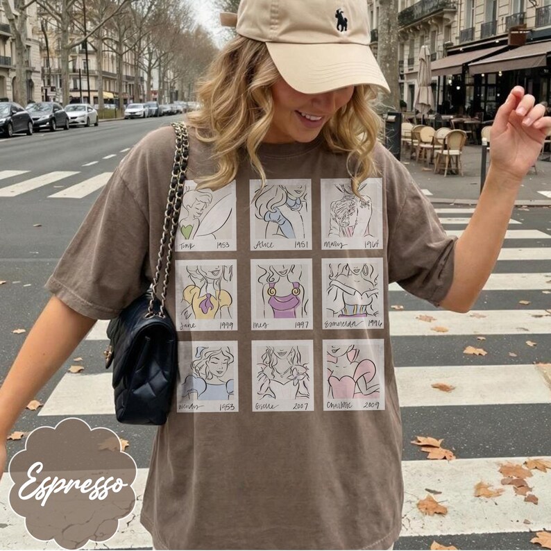 May include: Espresso-colored t-shirt featuring a grid of cartoon illustrations. The shirt has a crew neck and short sleeves. The illustrations are of various cartoon characters. The word "Espresso" is printed on the bottom left of the shirt.