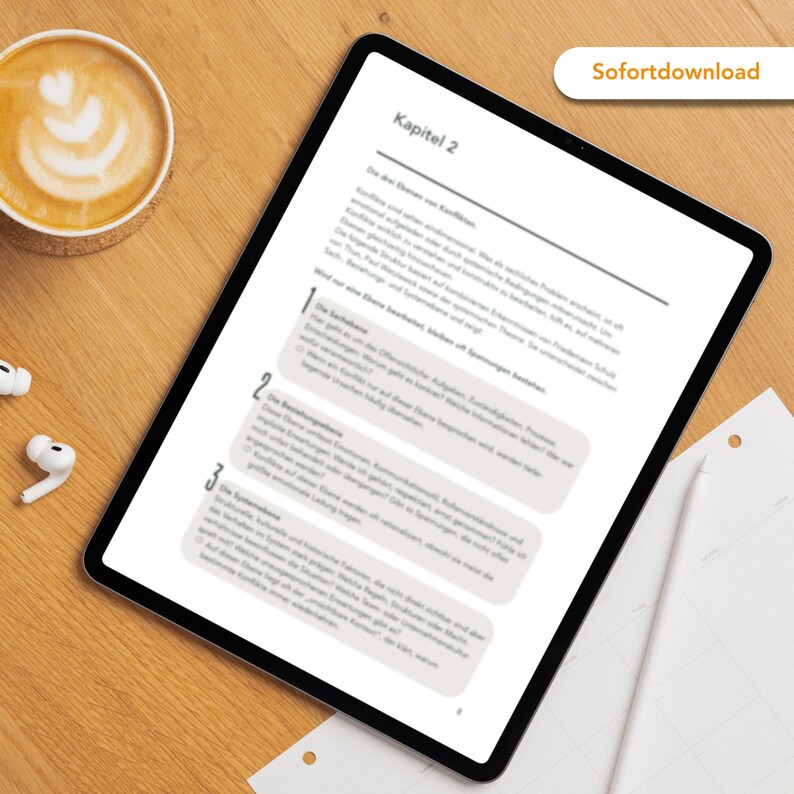 May include: A digital tablet displaying a document with German text, titled "Kapitel 2." The tablet rests on a wooden surface, accompanied by a cup of coffee with latte art, wireless earbuds, and a sheet of paper. A button reads "Sofortdownload."