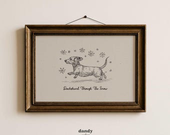 May include: A framed print featuring a sketched dachshund running through falling snowflakes. The artwork is in black and white, with the text "Dachshund Through The Snow" below the dog. The frame is a dark, ornate gold color.