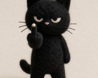 May include: A needle-felted black cat figurine with a textured wool surface, pointed ears, and long whiskers. The cat has a grumpy facial expression with cream-colored eyes and a small pink nose, and it is holding up one paw with an extended finger.