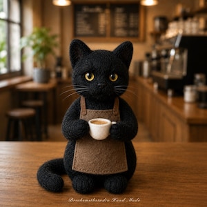 May include: A black felted cat figurine wearing a brown apron and holding a small white coffee cup. The cat has bright yellow eyes and long whiskers. The text "Bricksmithstudio Hand Made" is printed in white at the bottom of the image.