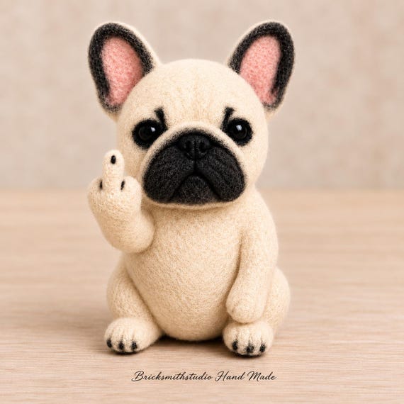 A needle-felted French Bulldog sculpture with an attitude — hand-sculpted at a level of detail and personality that makes it feel like wearable art for your shelf, not a mass-produced figurine.