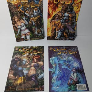 May include: Four comic books featuring fantasy art. The covers display the title "Grimm Fairy Tales" with various illustrations of characters and scenes. Each comic has a different number on the top left corner, and some have signatures.