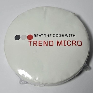 May include: A circular white coaster or pad encased in clear plastic film. The surface features three small circles in dark gray, light gray, and red, followed by the black text BEAT THE ODDS WITH and the red text TREND MICRO.