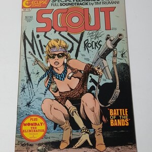 May include: A comic book titled Scout No. 19 from Eclipse Comics featuring a character with blonde hair, sunglasses, and a blue patterned scarf holding a rifle. The cover includes the text Missy Rocks, Battle of the Bands, and a red circle with text.