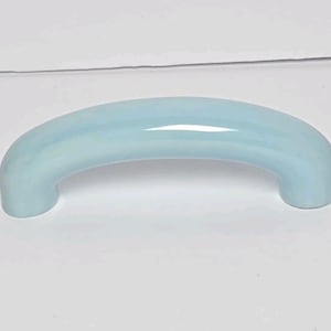 May include: A smooth, arched cabinet handle in a glossy, light baby blue finish. The hardware features a simple, curved design with rounded ends, providing a clean and uniform appearance suitable for various furniture or cabinetry applications.