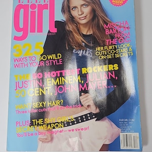 May include: A November/December 2003 issue of Elle Girl magazine featuring Mischa Barton on the cover. The cover includes text such as 325 Ways to Go Wild With Your Style, The 50 Hottest Rockers, and Want Sexy Hair? The background is a bright blue.