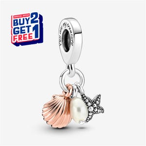 May include: A silver charm with a seashell, pearl, and starfish pendant. The seashell is rose gold, the pearl is white, and the starfish is silver. The charm has the text "You are my treasure".