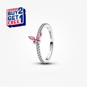 May include: A silver ring featuring a butterfly design with pink gemstone wings and smaller pink gemstone accents. The ring band is set with small, clear gemstones. The text "S925 ALE" and "PANDORA" are visible on the ring.