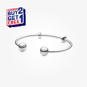 May include: A silver open bangle bracelet with two spherical end caps and two small, round accent beads. The bracelet has the text "OPA" engraved on one of the spherical end caps. A "BUY 2 GET 1 FREE" promotional graphic is in the upper left corner.