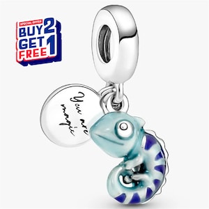 May include: A silver charm with a light blue and purple chameleon design. A round charm with the words "You are magic" hangs next to the chameleon. The charm has a silver loop at the top.