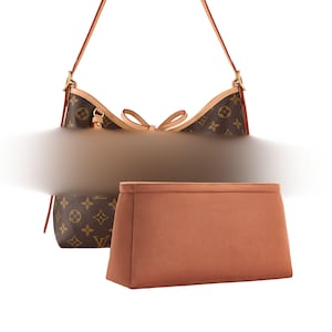 May include: A brown handbag with a monogram pattern, featuring a light brown trim and a matching interior organizer. The bag has a shoulder strap and a bow detail. The organizer is a solid, light brown color.
