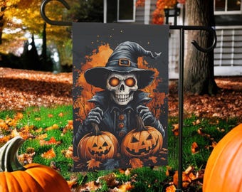 May include: Halloween garden flag featuring a spooky skeleton wearing a witch hat and holding two carved pumpkins. The design has orange and black colors, with a fall foliage background. The flag is displayed on a black metal stand.