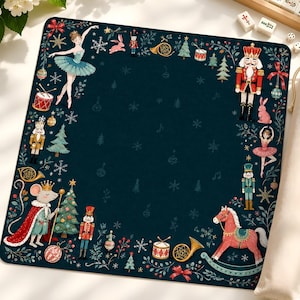 May include: A square dark green mat featuring a border of Nutcracker-themed illustrations including ballerinas, toy soldiers, a mouse king, a rocking horse, Christmas trees, drums, and snowflakes, accompanied by a beige fabric drawstring storage bag.