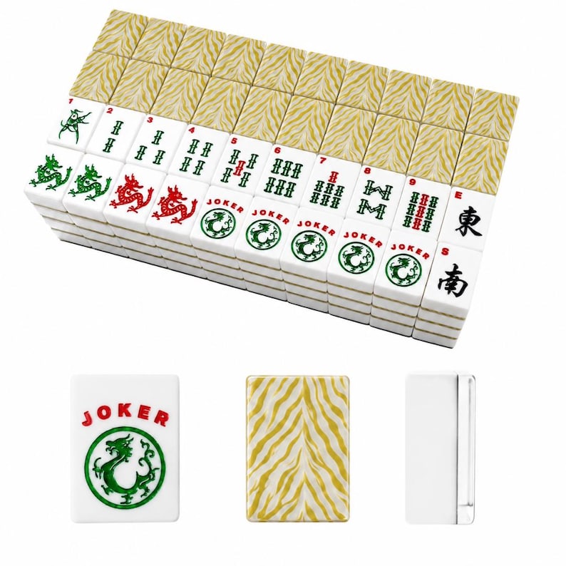 May include: A set of white Mahjong tiles featuring green and red ink designs, including dragons, numbers, and Joker labels. The backs of the tiles display a gold and white tiger stripe pattern. Three individual tiles are shown below the main stack.